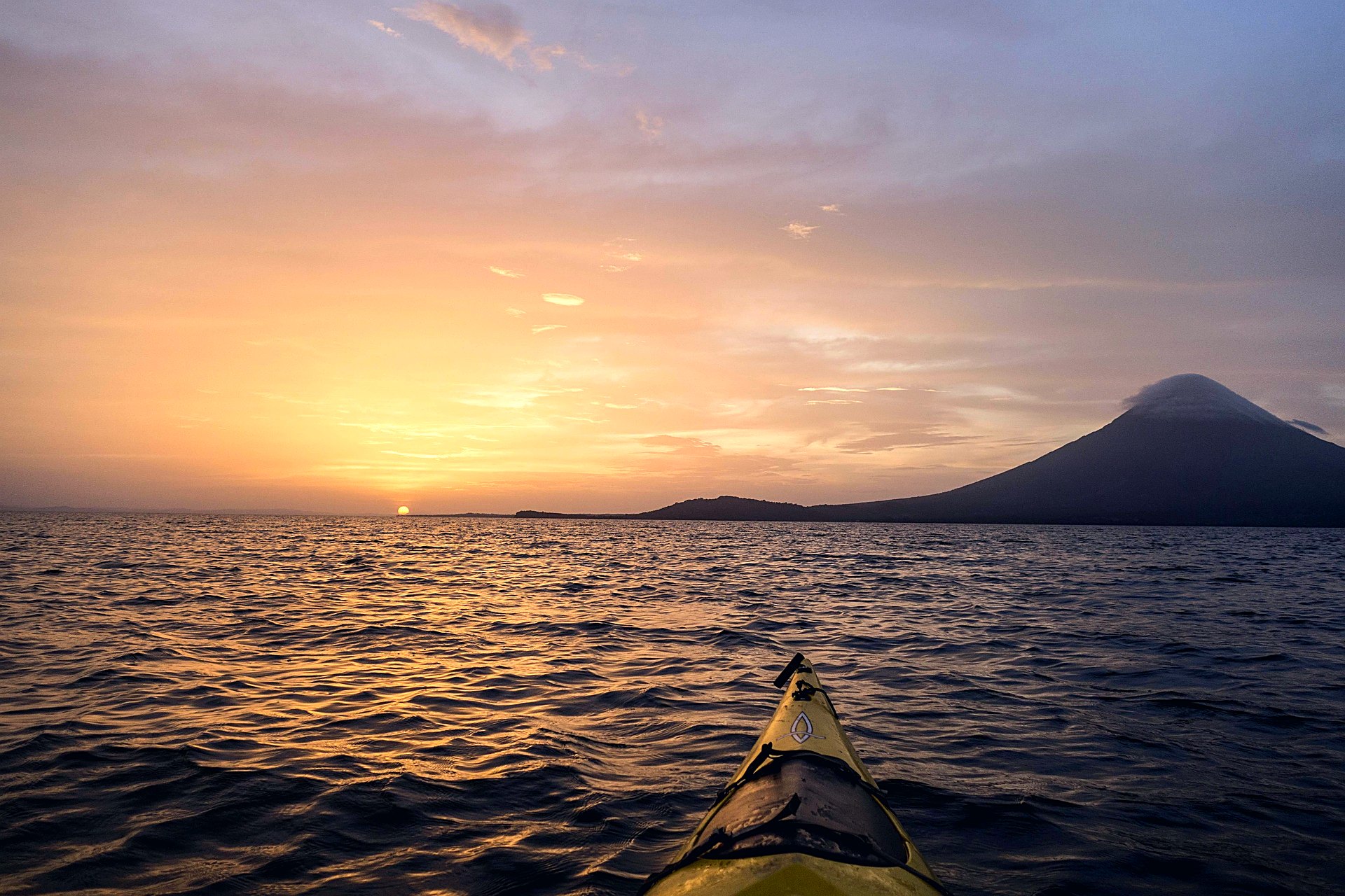 Kayak on Lake Nicaragua at sunset with Ometepe Island in the distance