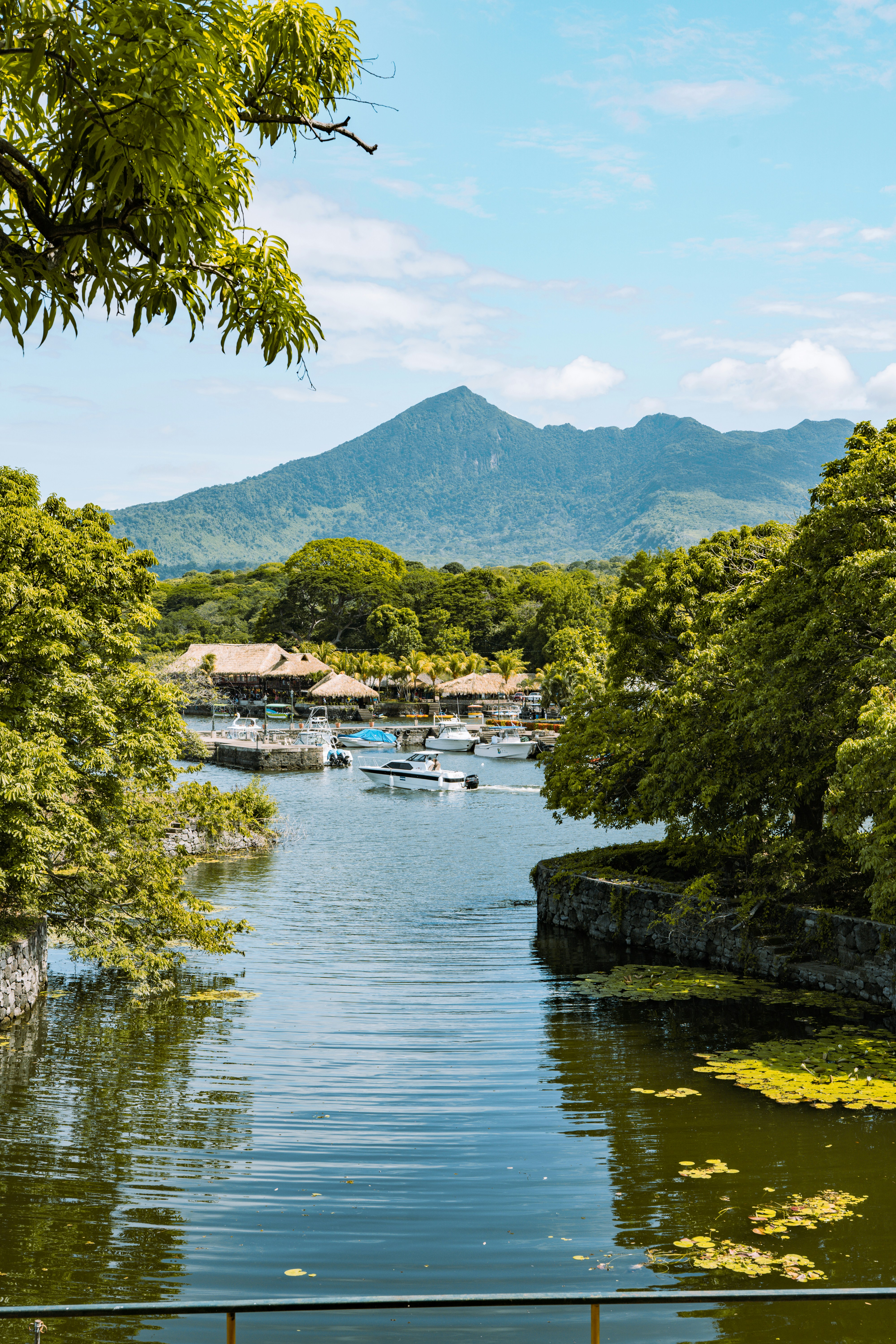 Calm water surrounded by tropical vegetation and mountains in Nicaragua